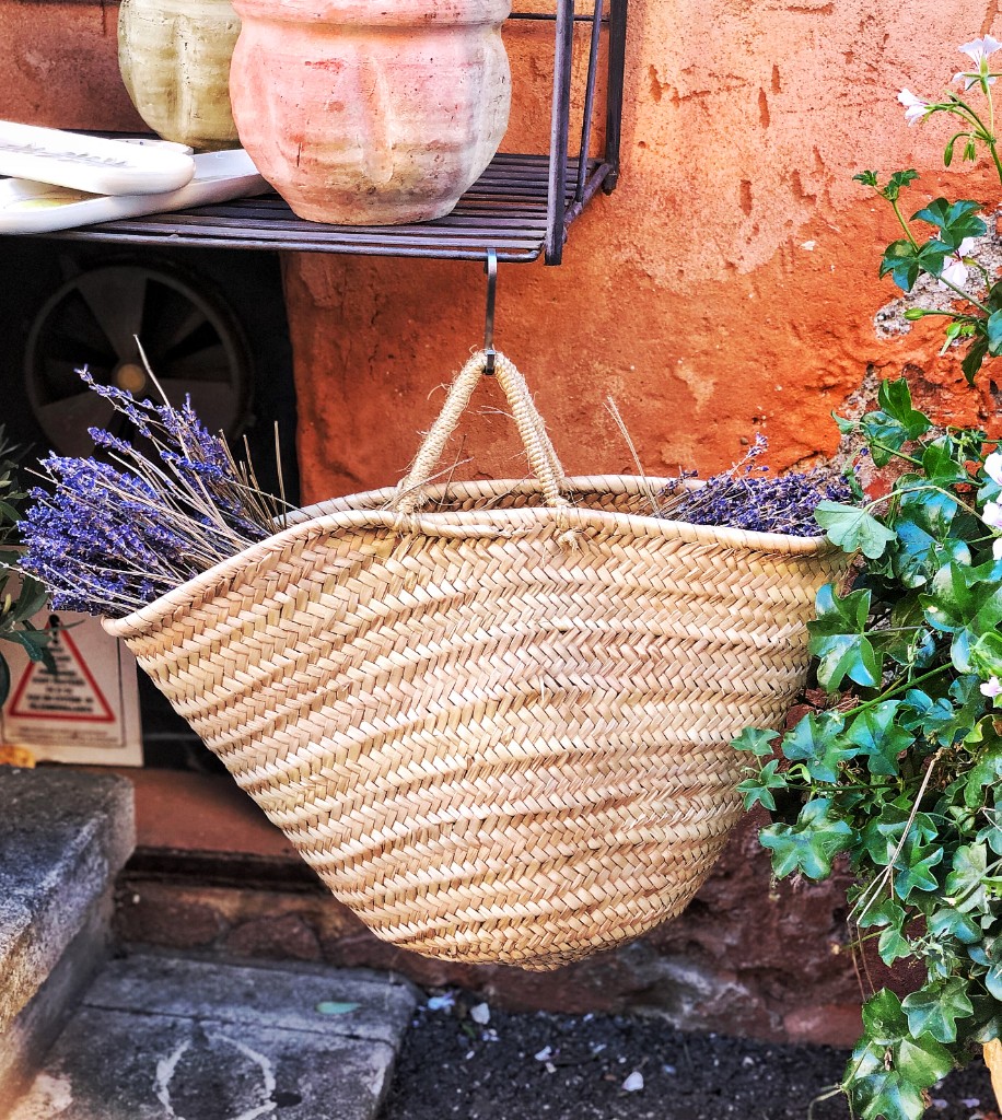 Woven basket of dried lavender against a sun-warmed wall in Saint-Rémy-de-Provence
